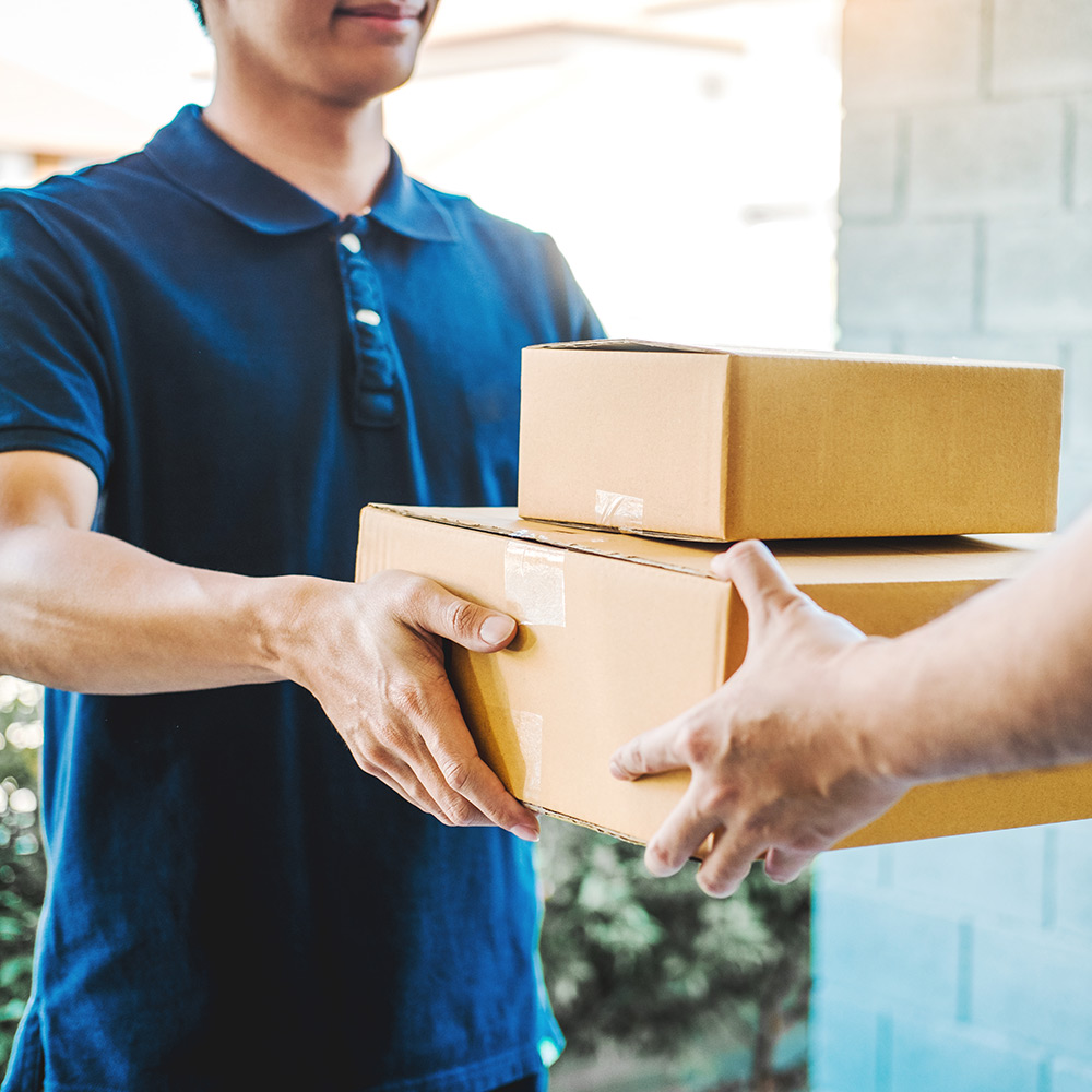 Courier delivering cardboard boxed packages 